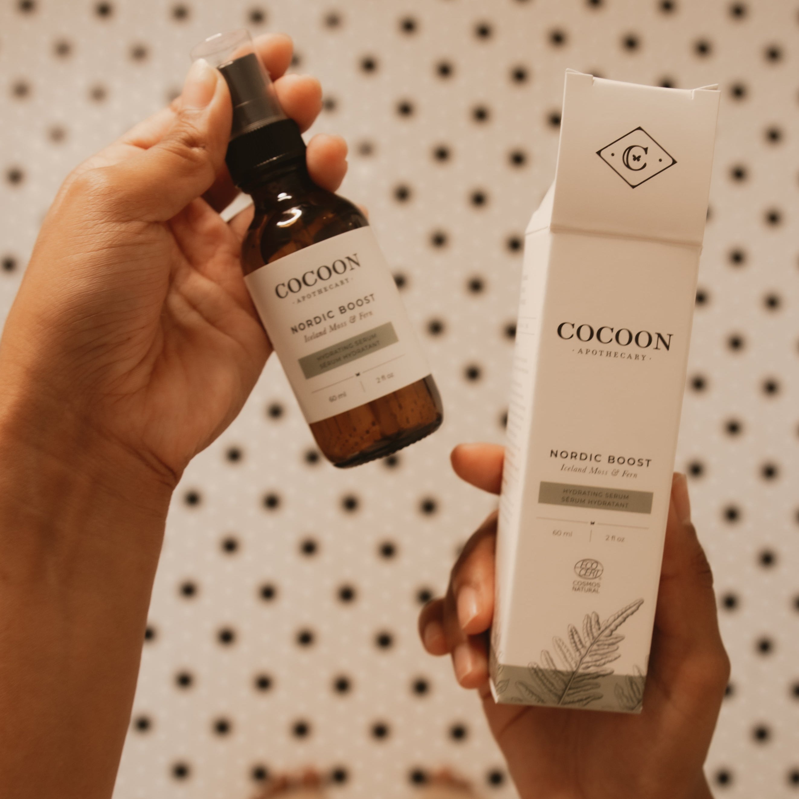 Cocoon Nordic Boost skincare product with bottle and packaging against a patterned background
