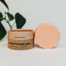 Zero waste conditioner bar with packaging on a white background