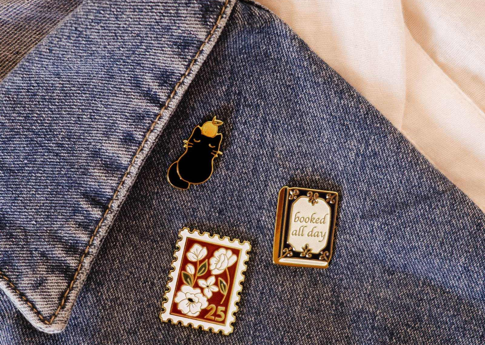 Denim jacket with decorative pins on a light background mimi-and-august