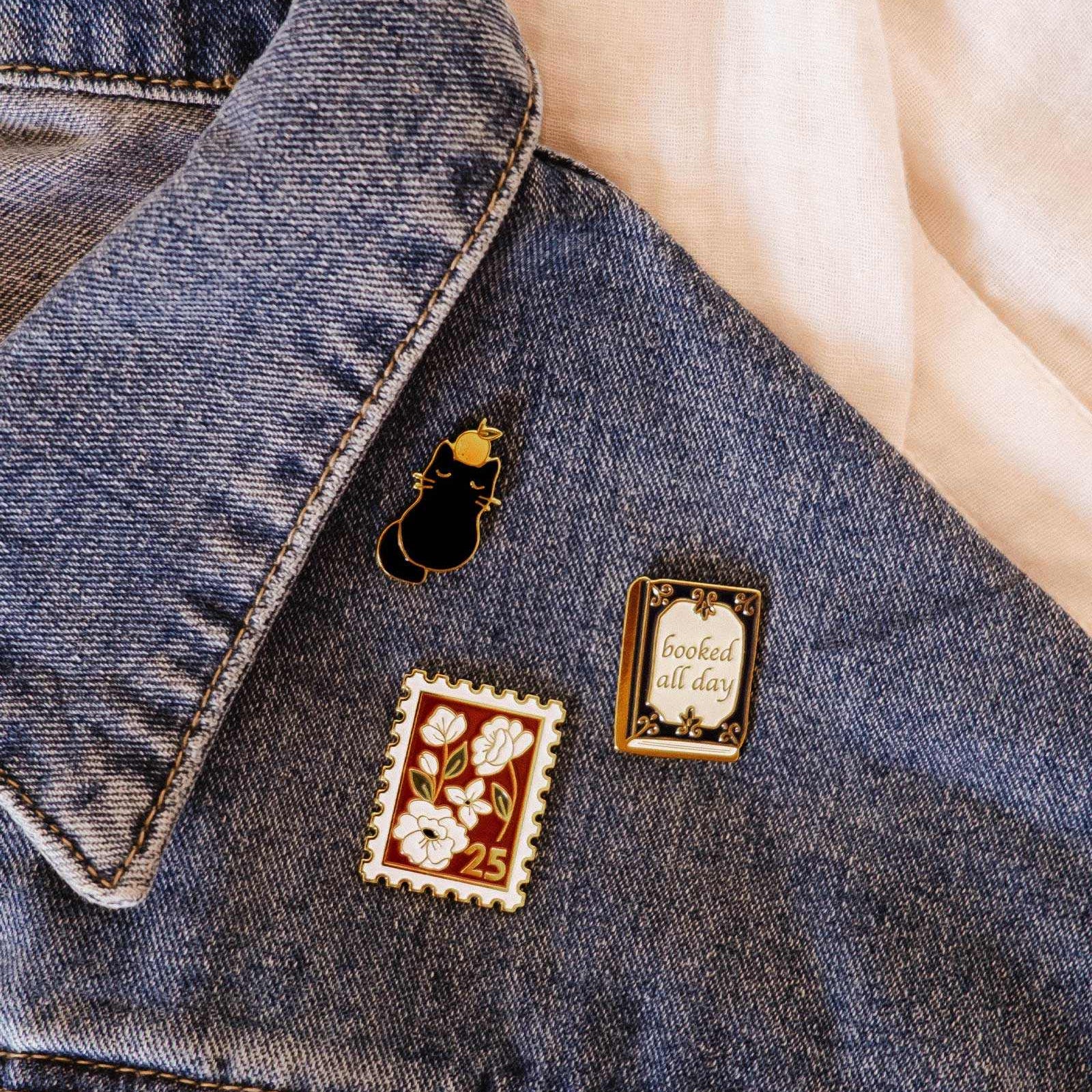 Denim jacket with decorative pins on a light background mimi-and-august