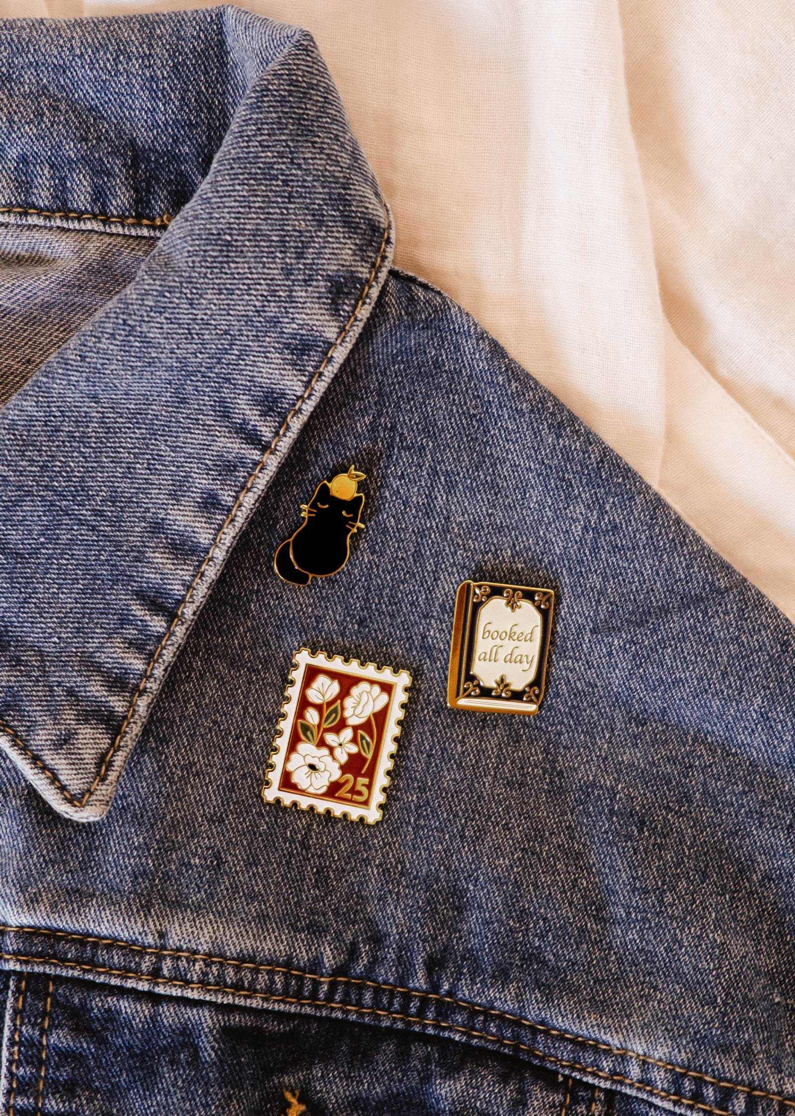 Denim jacket with decorative pins on a light background mimi-and-august