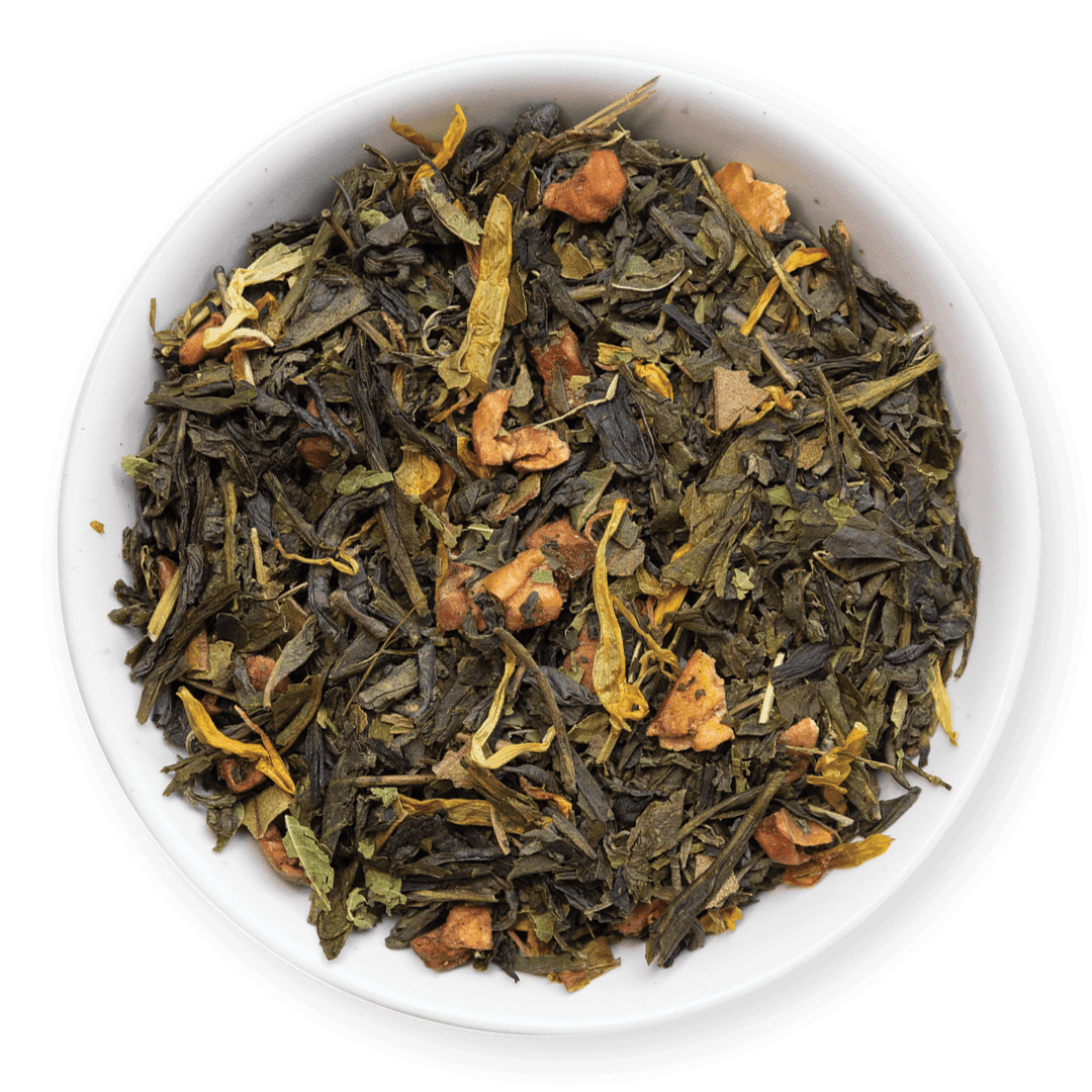 Tea leaves with orange pieces in a white bowl on a dark background