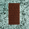earl grey lavander chocolate bar with geometric pattern on a textured green background