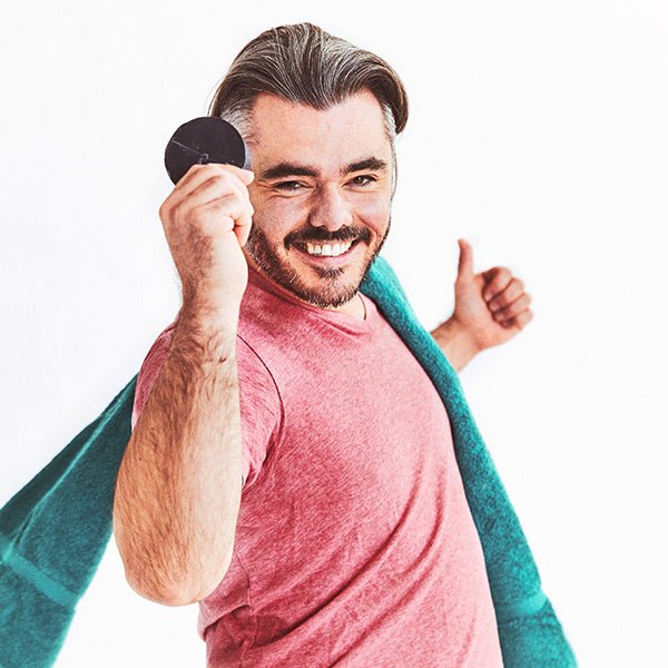 Man holding a black object with a white background