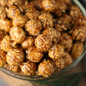 Bowl of espresso caramel candied popcorn on a wooden surface from Toronto Popcorn company