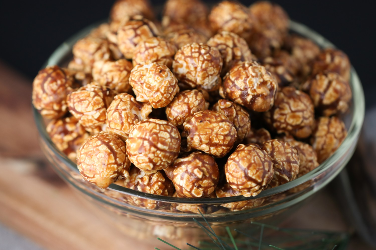 Close up of a Bowl of espresso caramel candied popcorn on a wooden surface from Toronto Popcorn company
