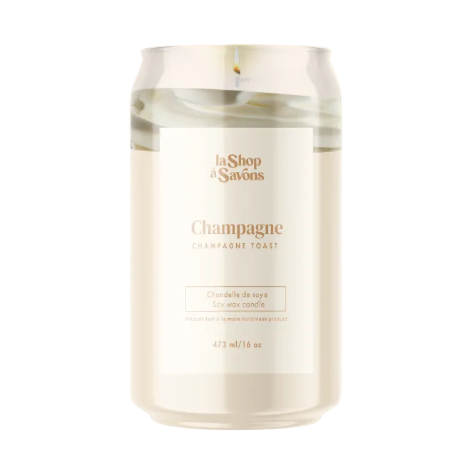 Candle in a glass jar labeled 'Champagne Toast' by 'La Shop des Savons' on a white background