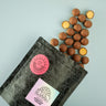Gingerbread balls with a branded packaging on a light blue background