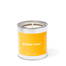 Candle in a metal can with a yellow label on a white background