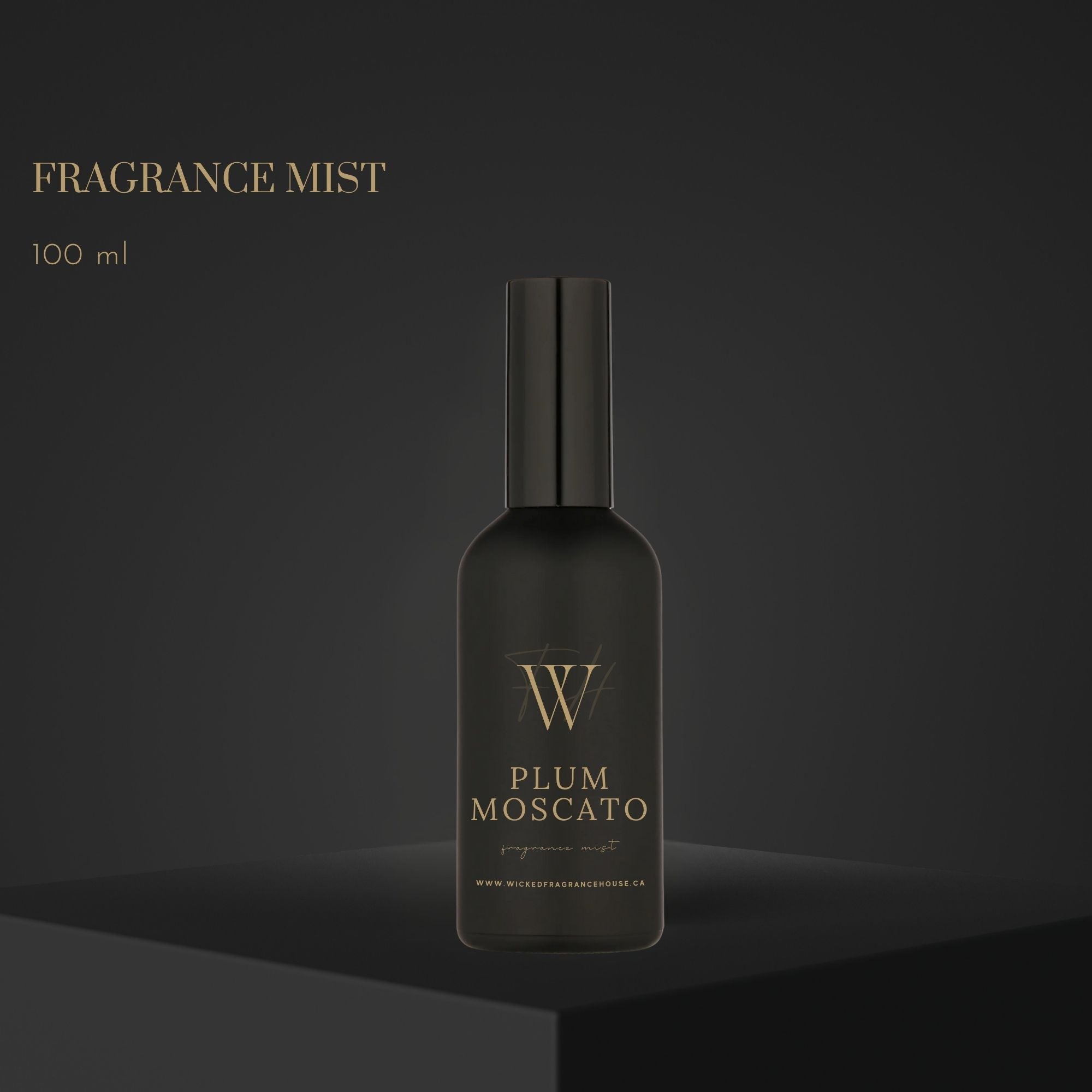 Black fragrance mist bottle labeled 'Plum Moscato' on a dark background