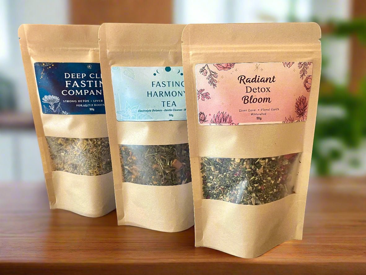 Kootenay Woman Three tea packages with labels on a wooden surface