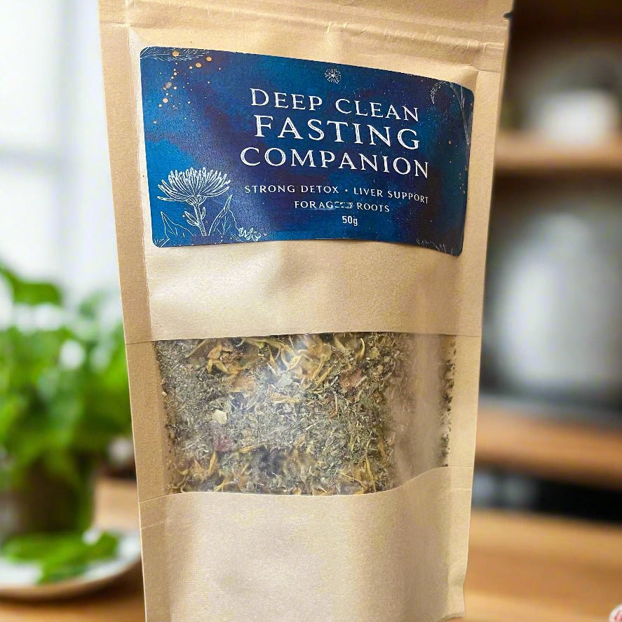Kraft paper packaging of 'Deep Clean Fasting Companion' on a wooden surface with a blurred background. Kootenay Woman