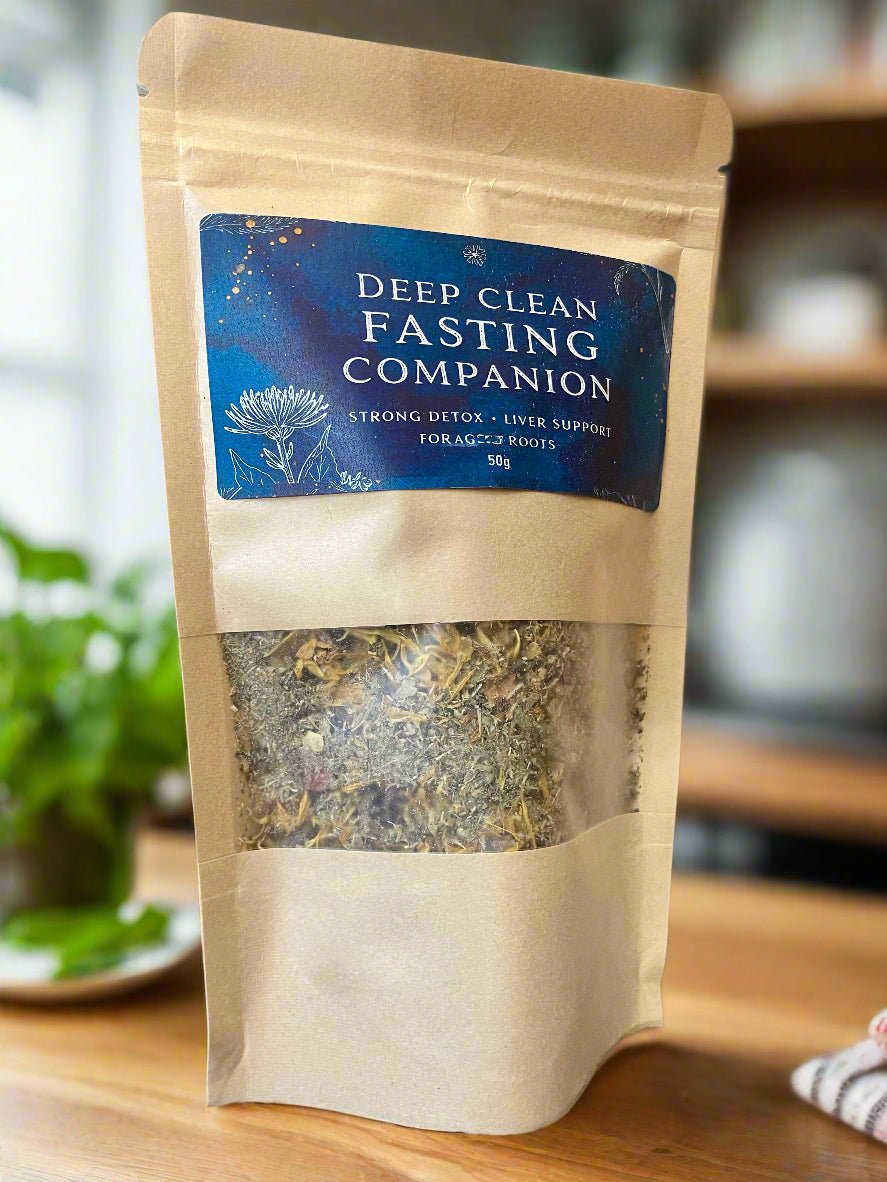 Kraft paper packaging of 'Deep Clean Fasting Companion' on a wooden surface with a blurred background. Kootenay Woman