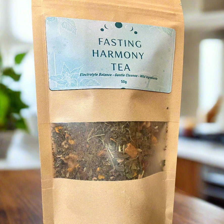 Bag of Fasting Harmony Tea with a label on a wooden surface Kootenay Woman