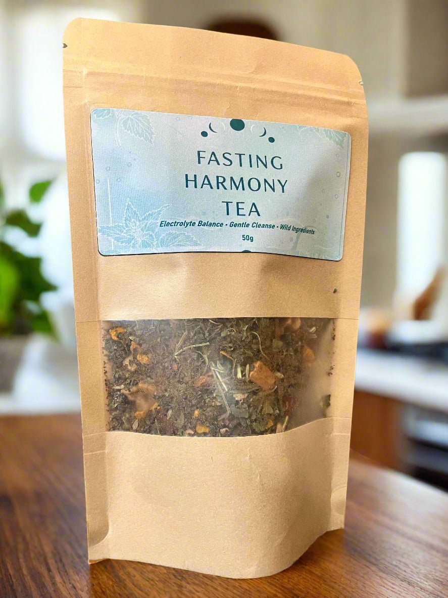 Bag of Fasting Harmony Tea with a label on a wooden surface Kootenay Woman