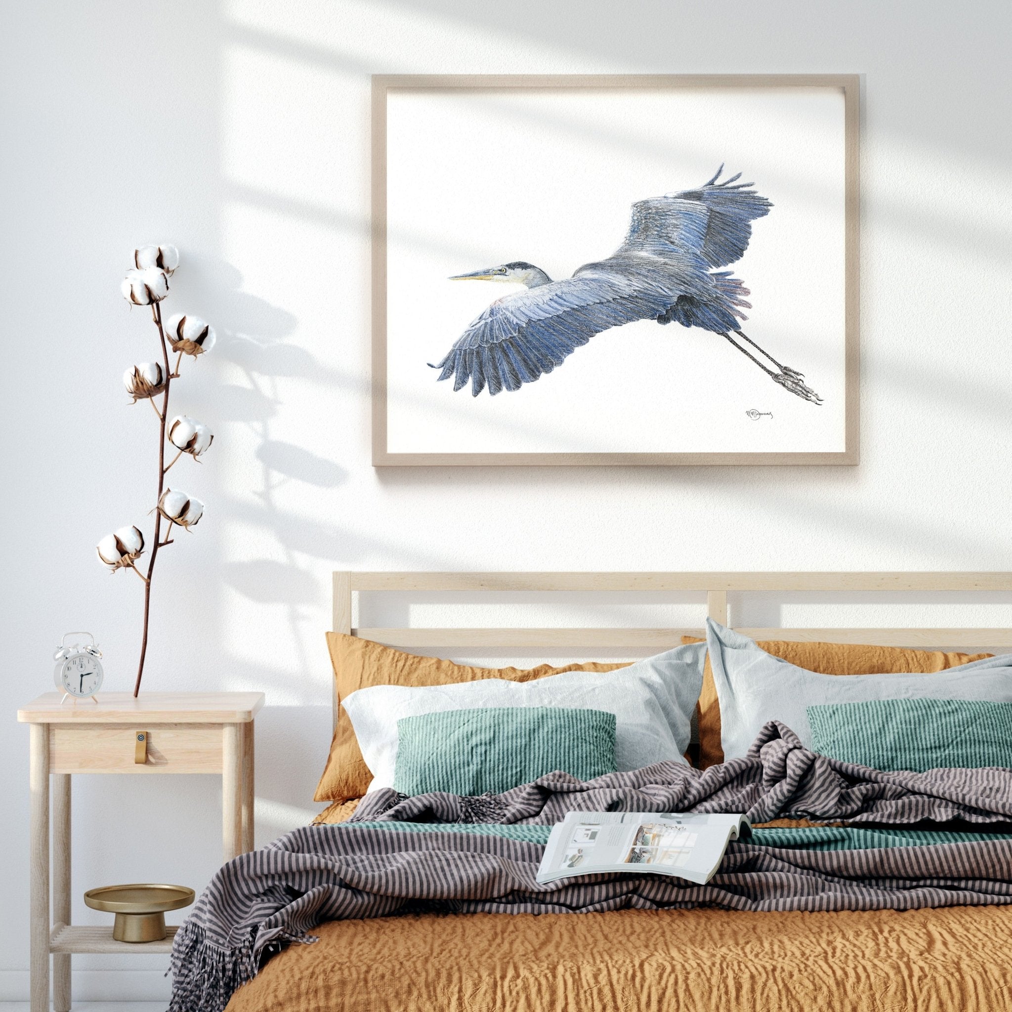Bedroom with a bed, nightstand, and wall art of a bird