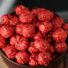 close view of a Bowl of hot cinnamon candied popcorn on a wooden surface from Toronto Popcorn company