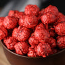 Bowl of hot cinnamon candied popcorn on a wooden surface from Toronto Popcorn company