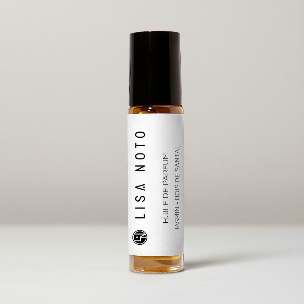 A small glass rollerball perfume bottle with amber liquid, a black cap, and a white label reading LISA NOTO and HUILE DE PARFUM JASMIN - BOIS DE SANIAL, centered on a light gray background.