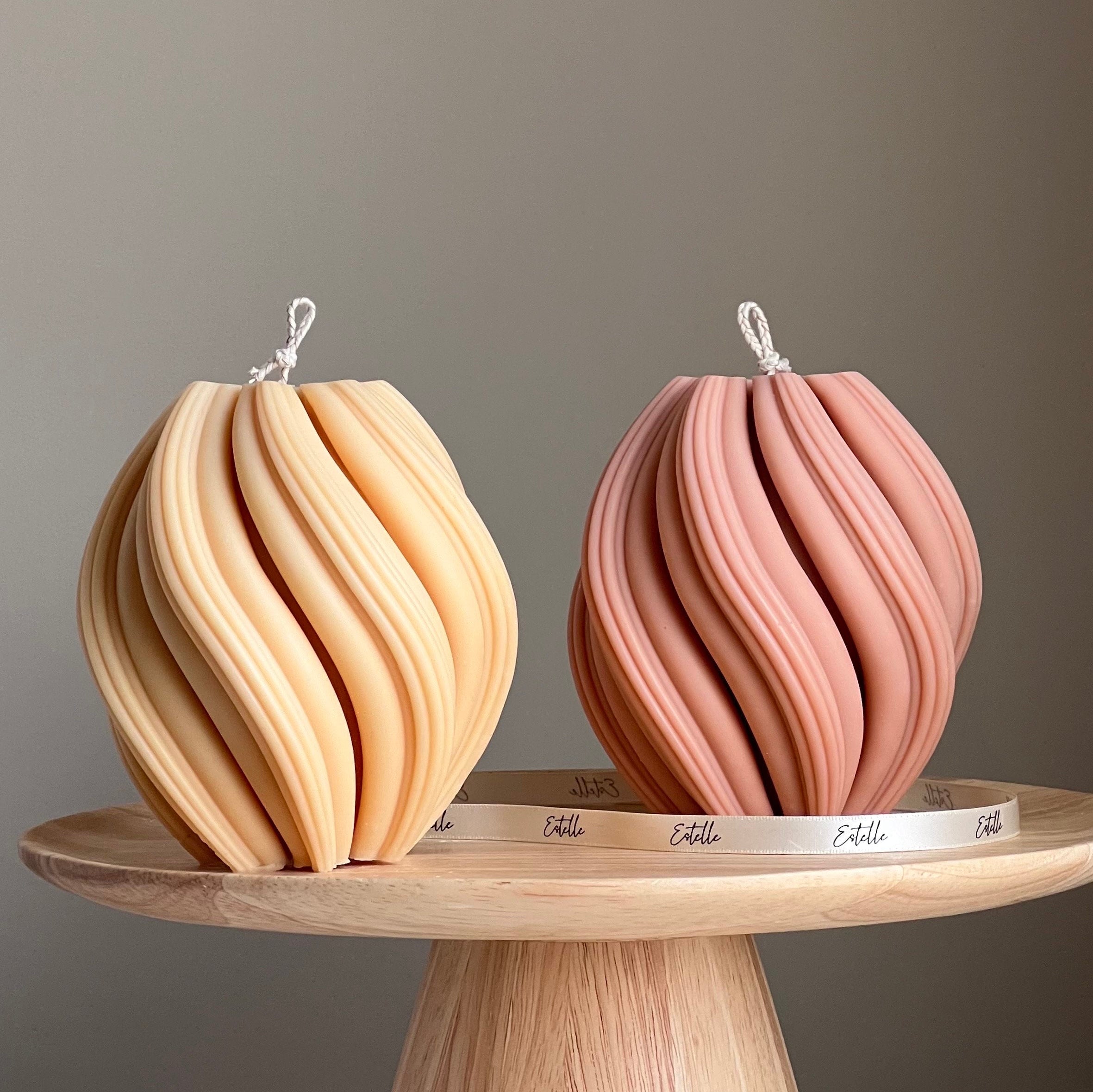 Two decorative items on a wooden stand with a neutral background