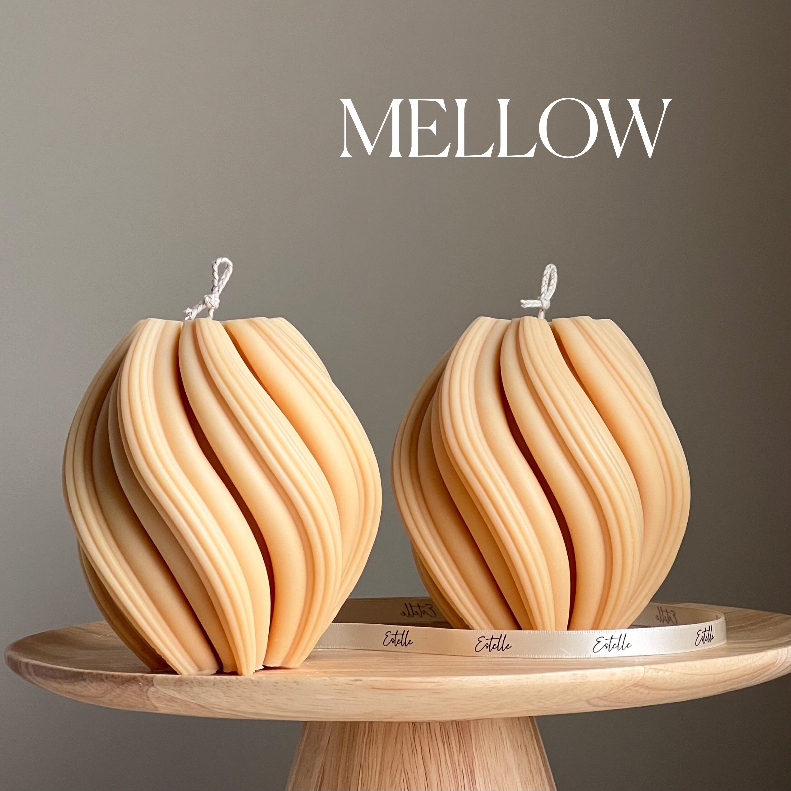 Two wooden decorative items on a stand with 'MELLOW' branding.