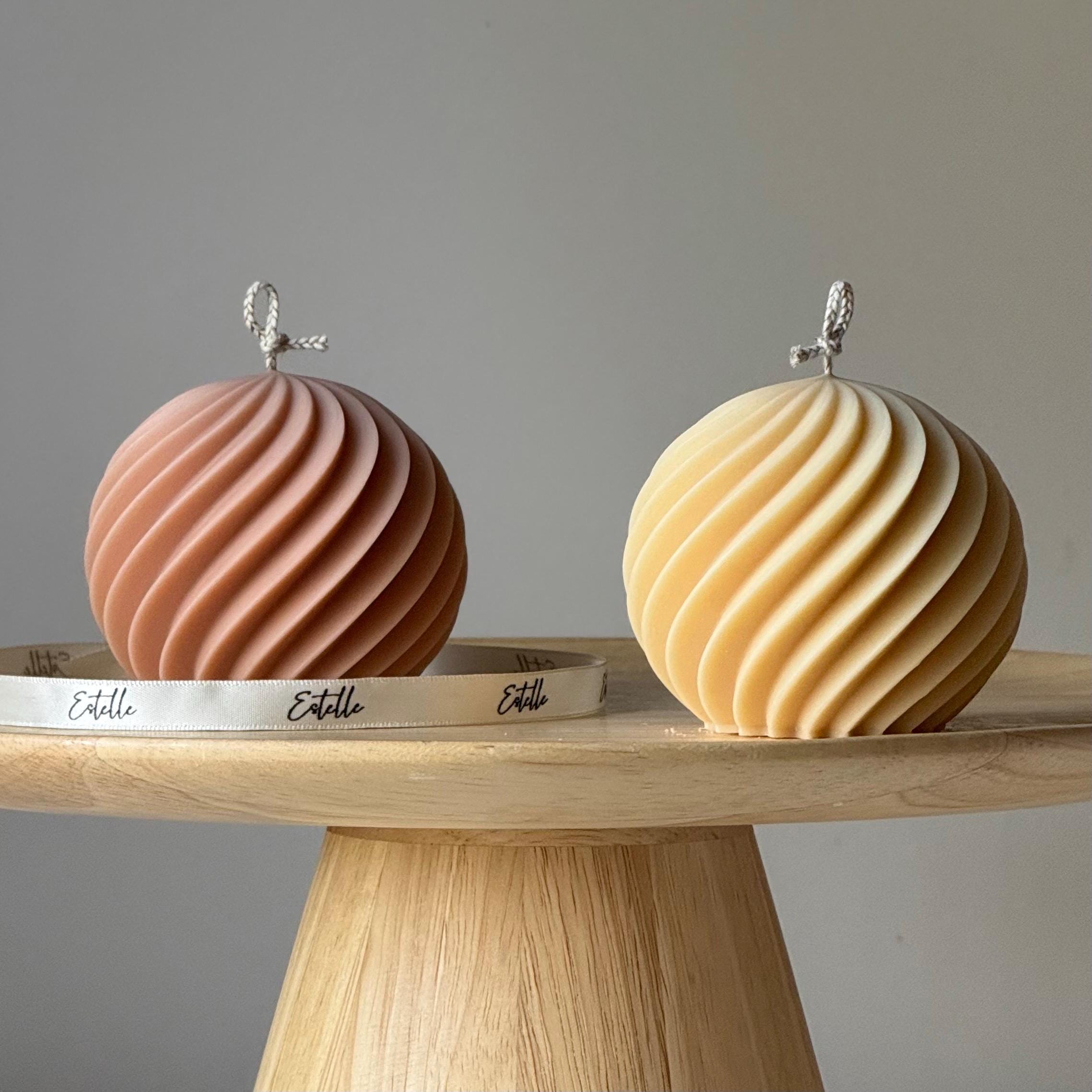 Two decorative items on a wooden stand with a neutral background