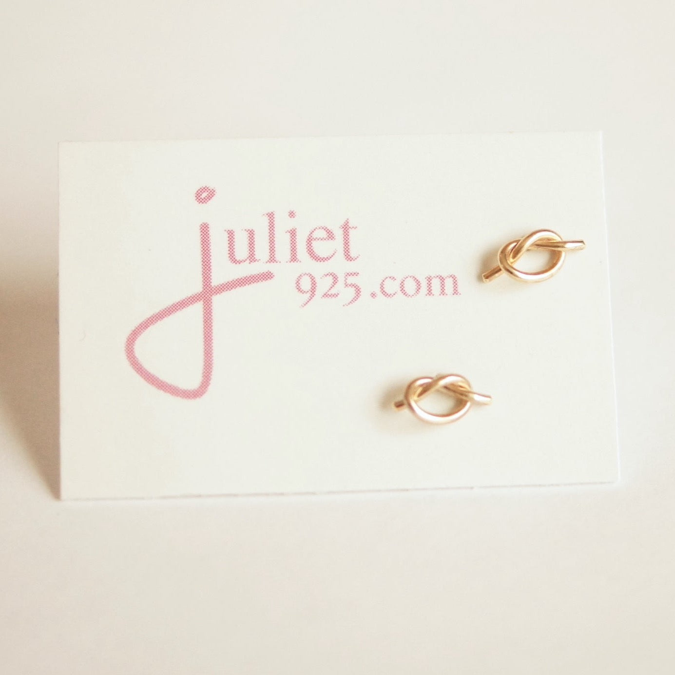 Gold earrings on a ' Juliet 925' branded card