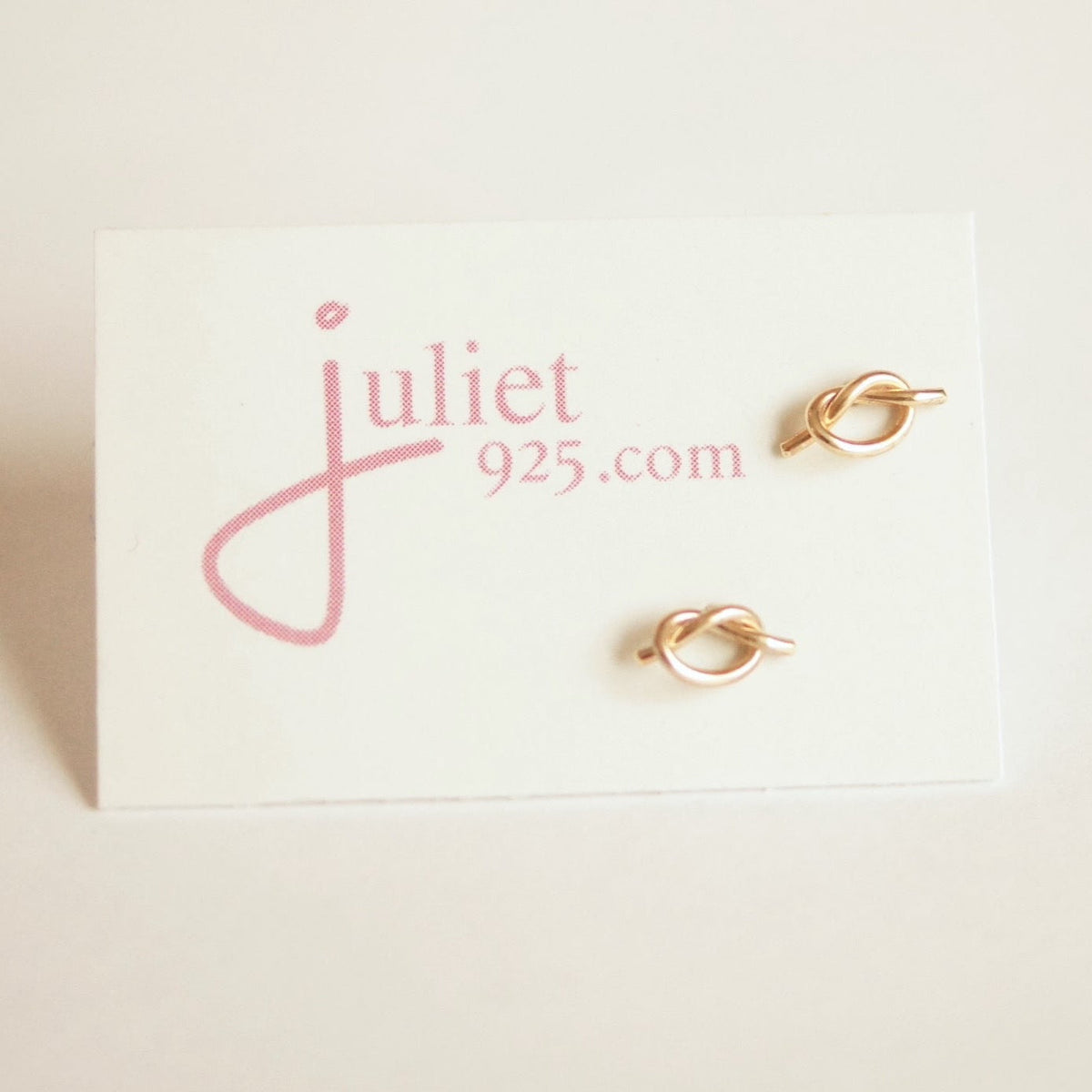 Gold earrings on a ' Juliet 925' branded card