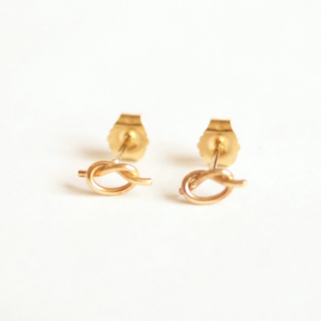 Pair of gold earrings on a white background
