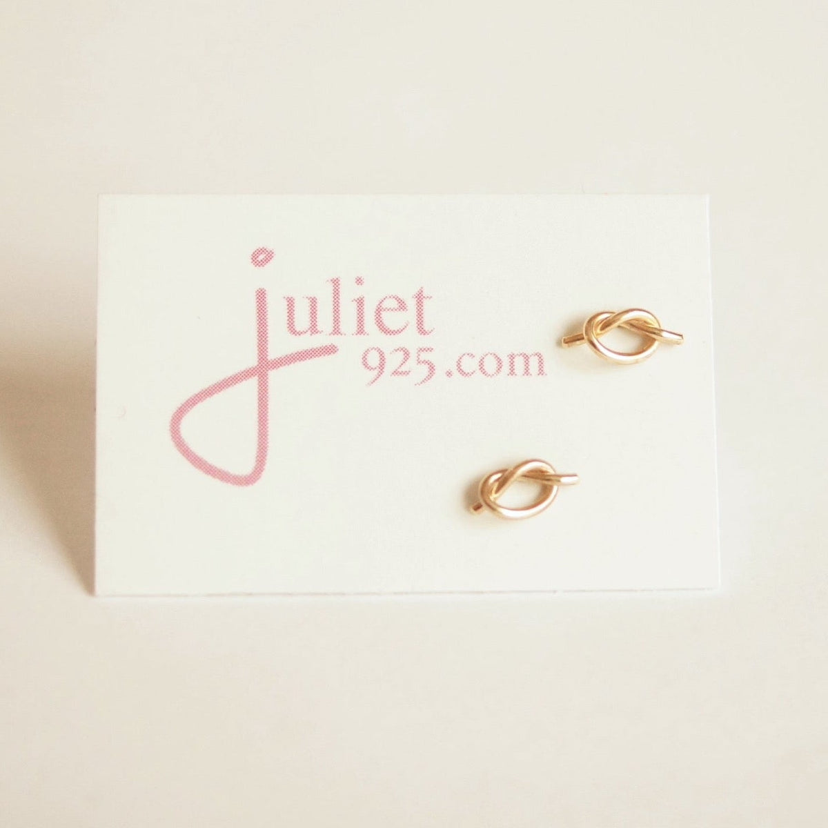 Gold earrings on a 'juliet 925' branded card