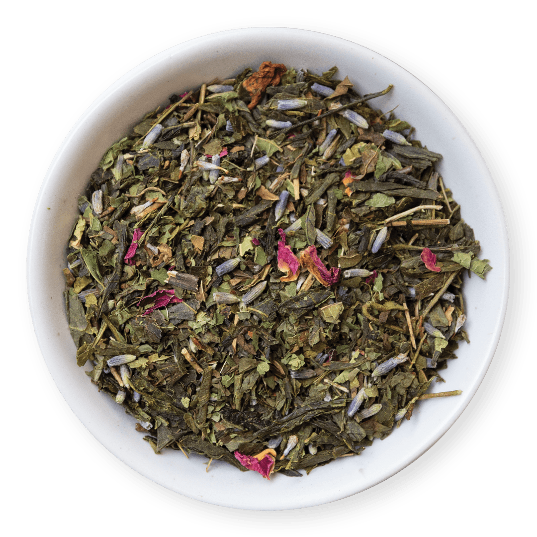 White bowl filled with green tea leaves and small pink flowers on a dark background