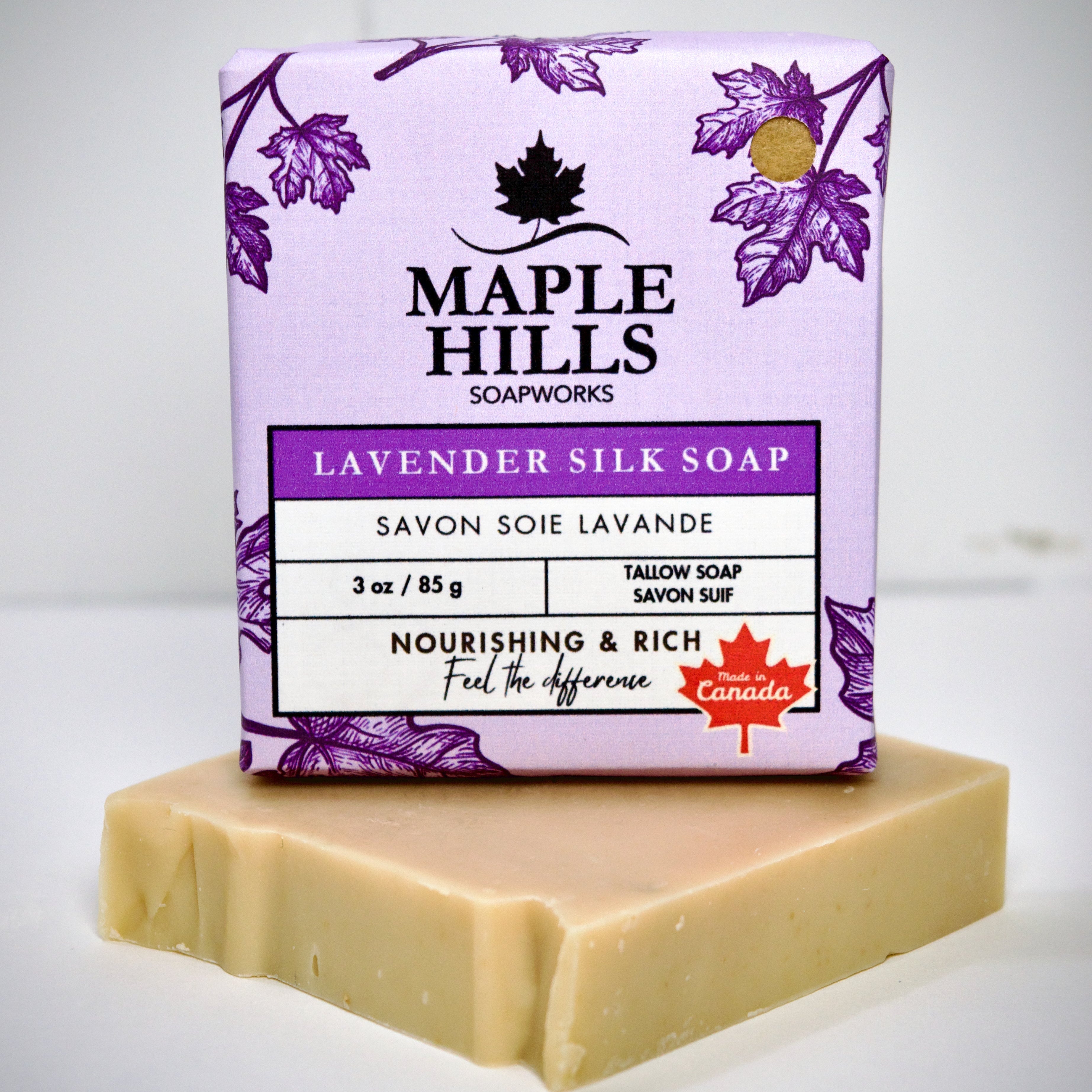 Bar of soap with a purple Maple Hills Soapworks packaging on a white background