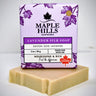 Bar of soap with a purple Maple Hills Soapworks packaging on a white background