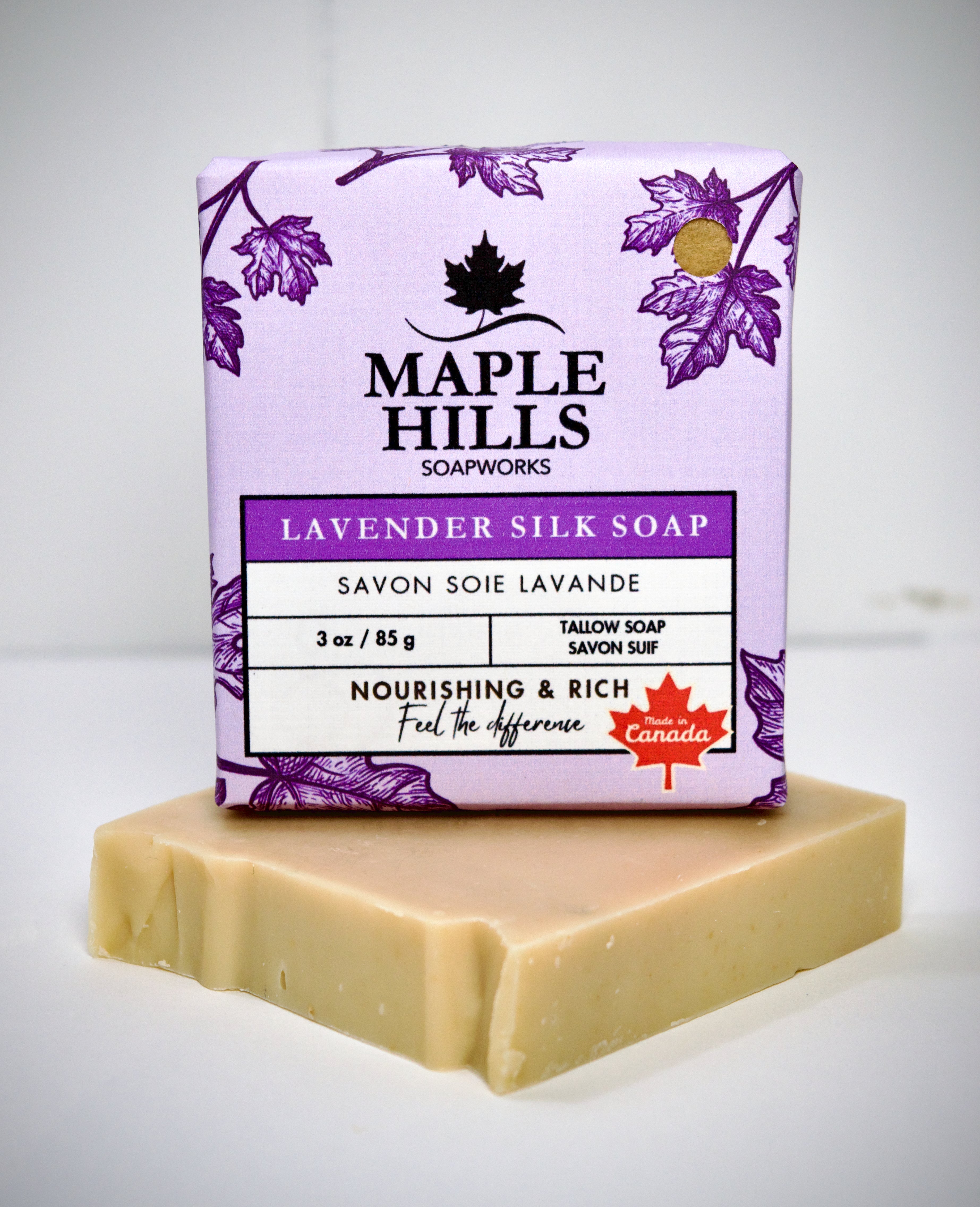 Bar of soap with a purple Maple Hills Soapworks packaging on a white background