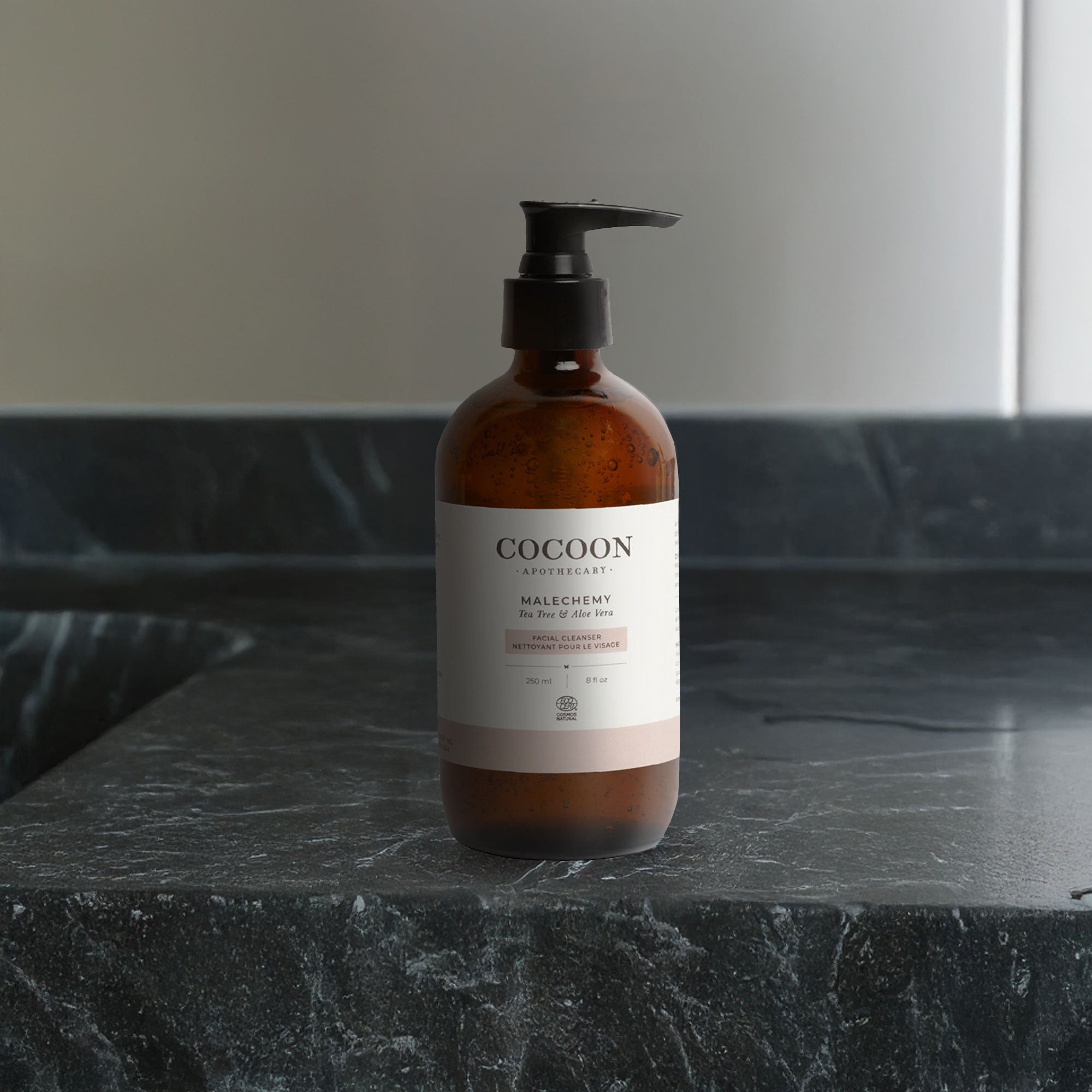 Cocoon bottle on a dark marble surface with a neutral background
