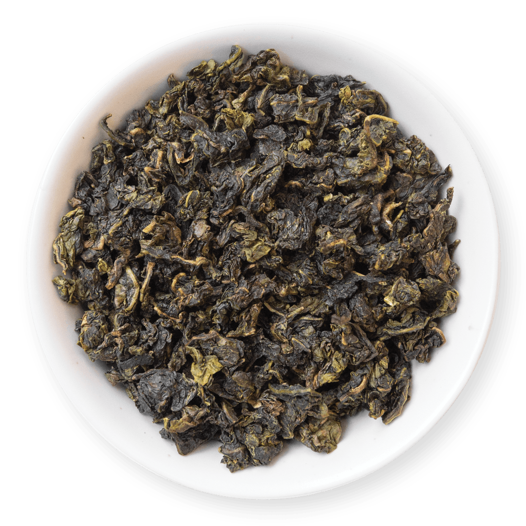 Dry green tea leaves in a white bowl on a blue background