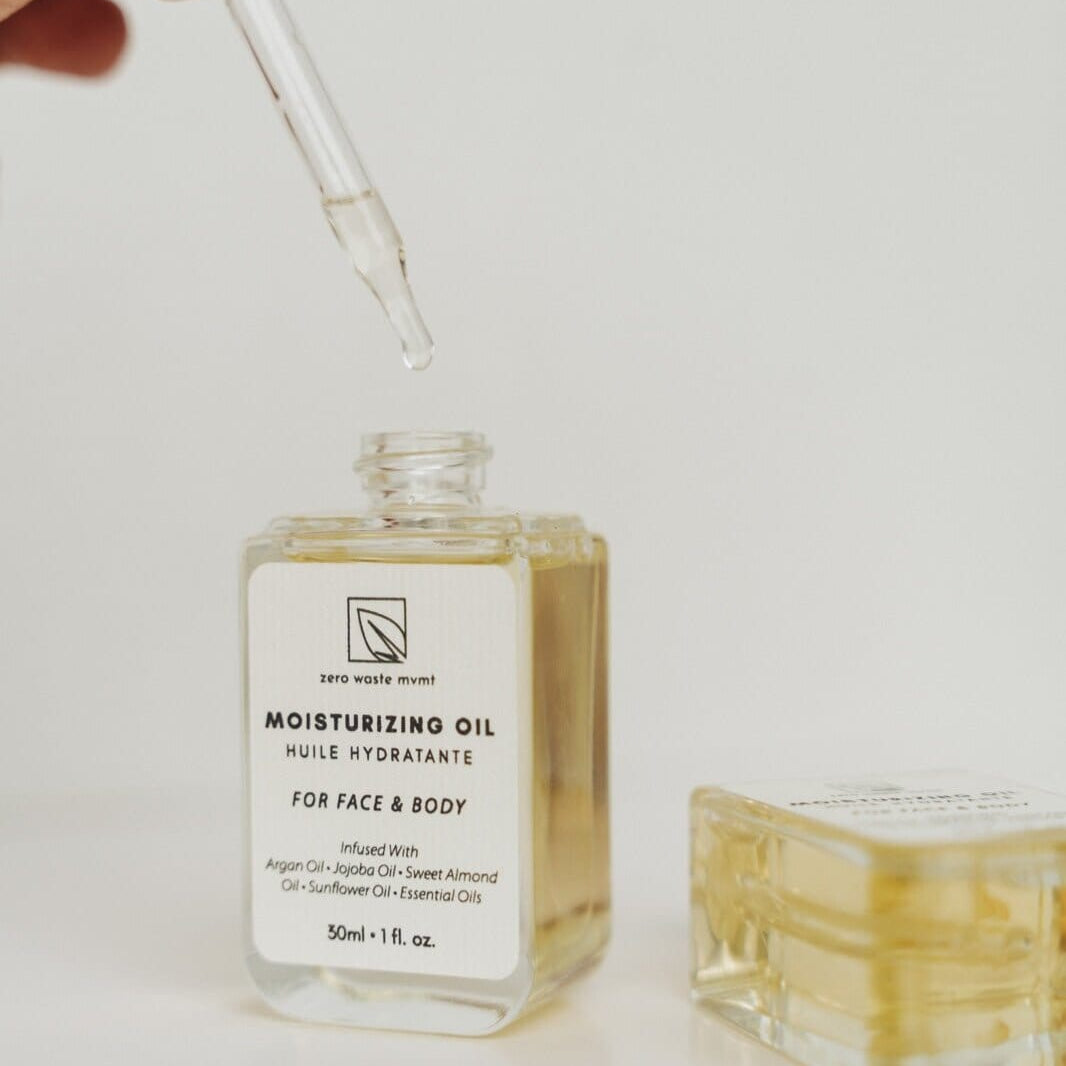 Moisturizing oil bottle with dropper on a light background