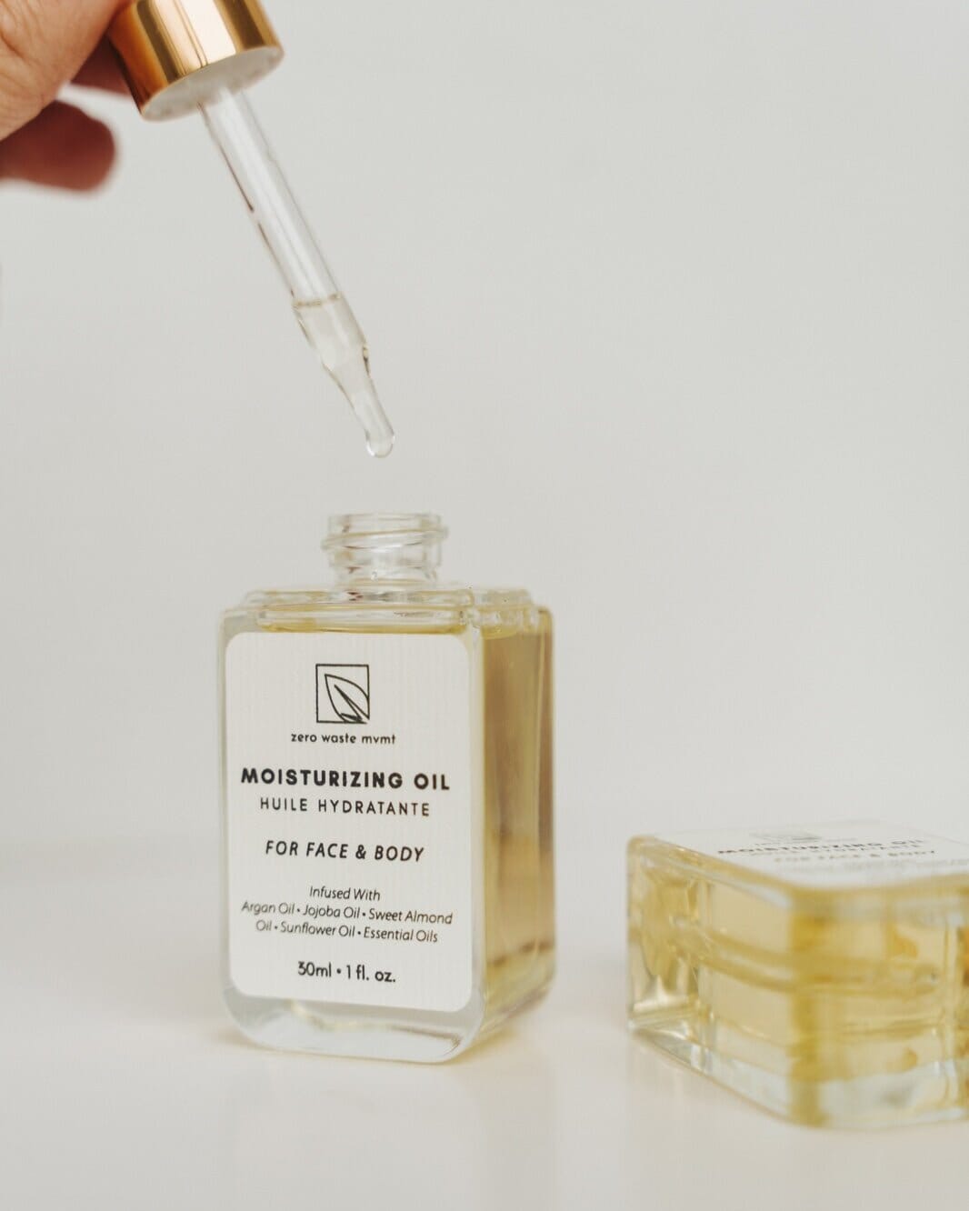 Moisturizing oil bottle with dropper on a light background