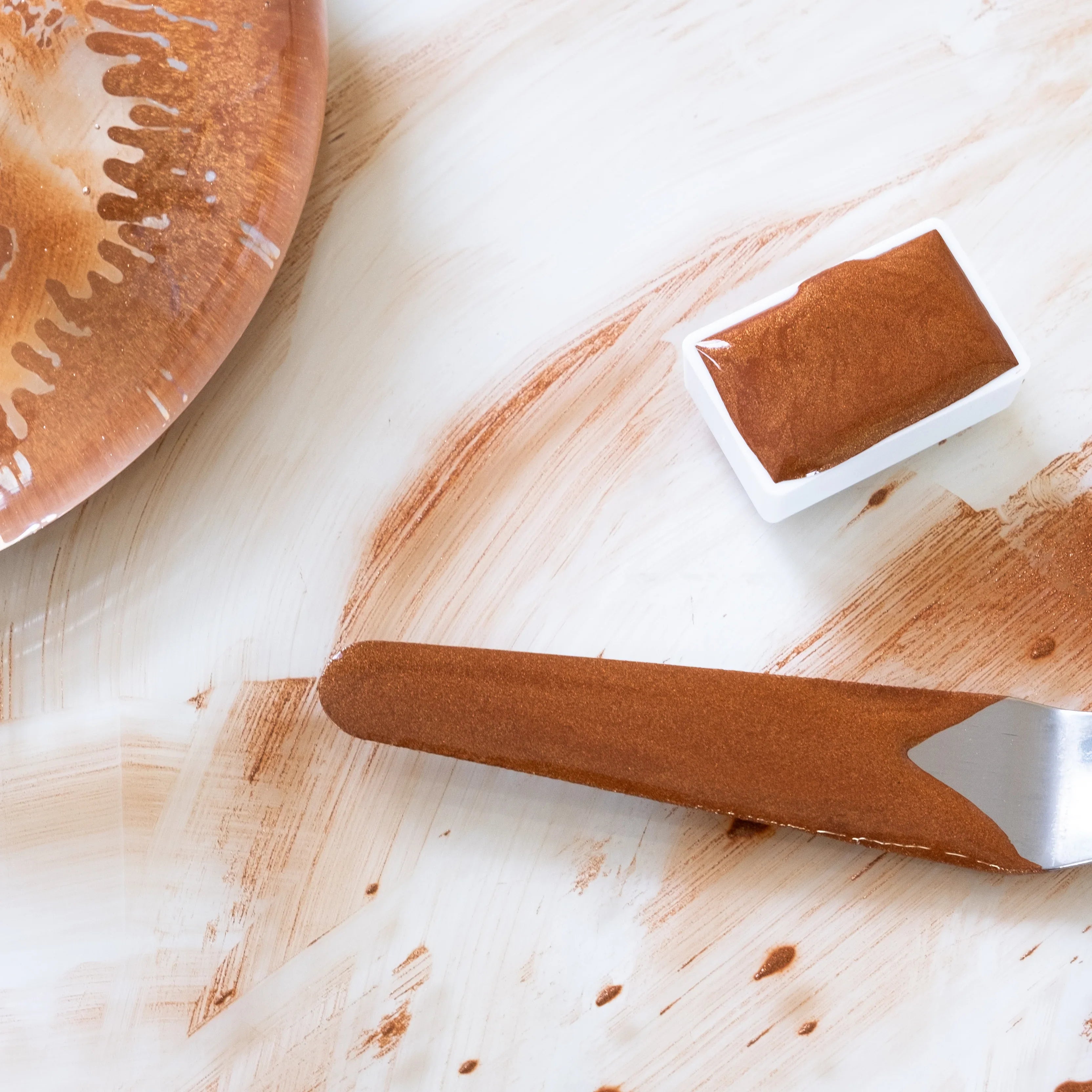 Wooden spatula with brown butter on a marble surface