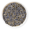 Dry lavender flowers in a white bowl on a dark background