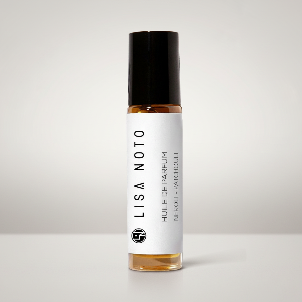 A clear glass rollerball perfume bottle with amber liquid, a black cap, and a white label reading 'LISA NOTO' and 'HUILE DE PARFUM NEROL - PATCHOUli', centered on a light gray background.