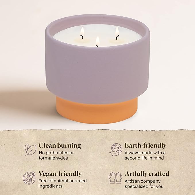 Candle in a purple container with a beige base on a light background, featuring eco-friendly attributes.