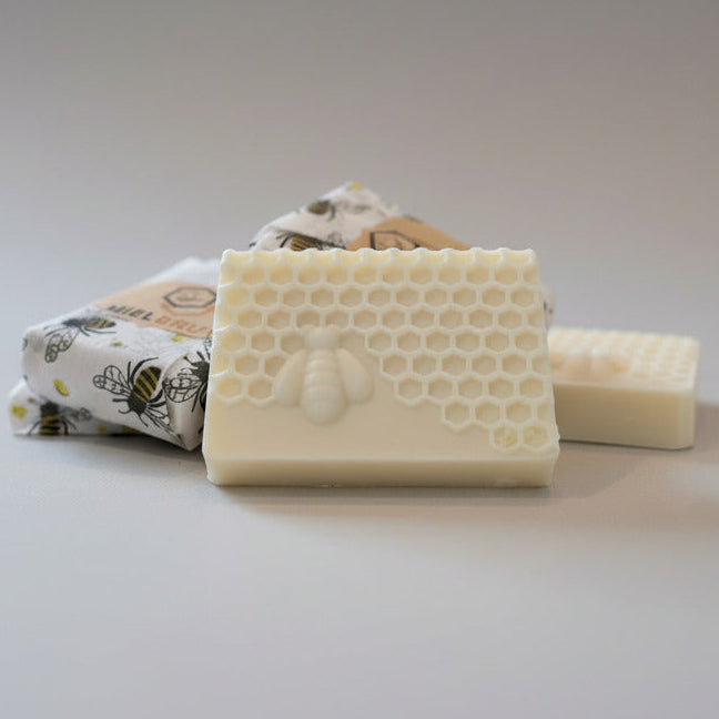 Three soap bars with different designs on a light gray background
