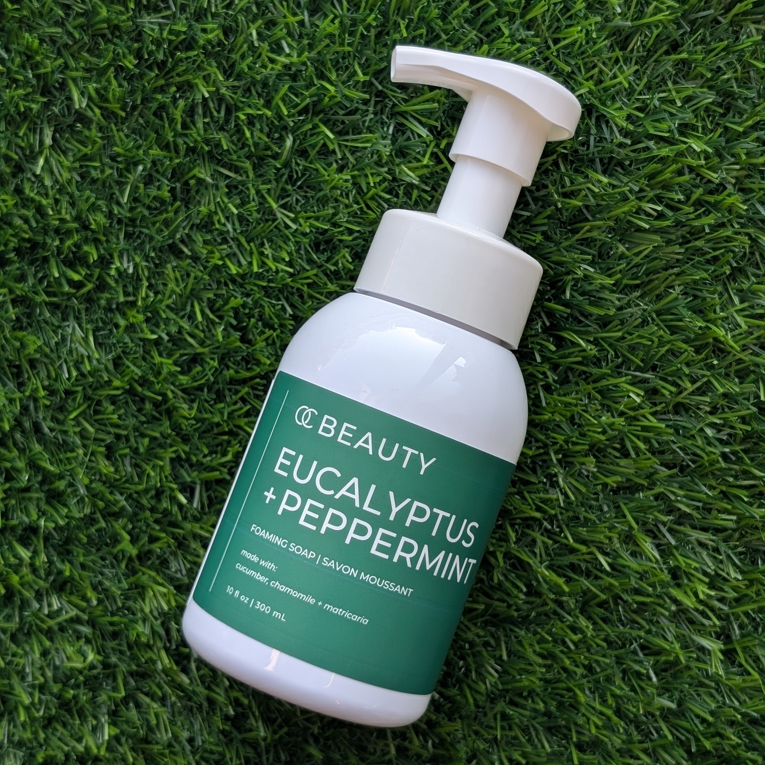 Eucalyptus + Peppermint Foaming Hand Soap with pump on a grass background