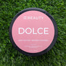 OC Beauty Body butter container labeled 'Dolce' on a grass background