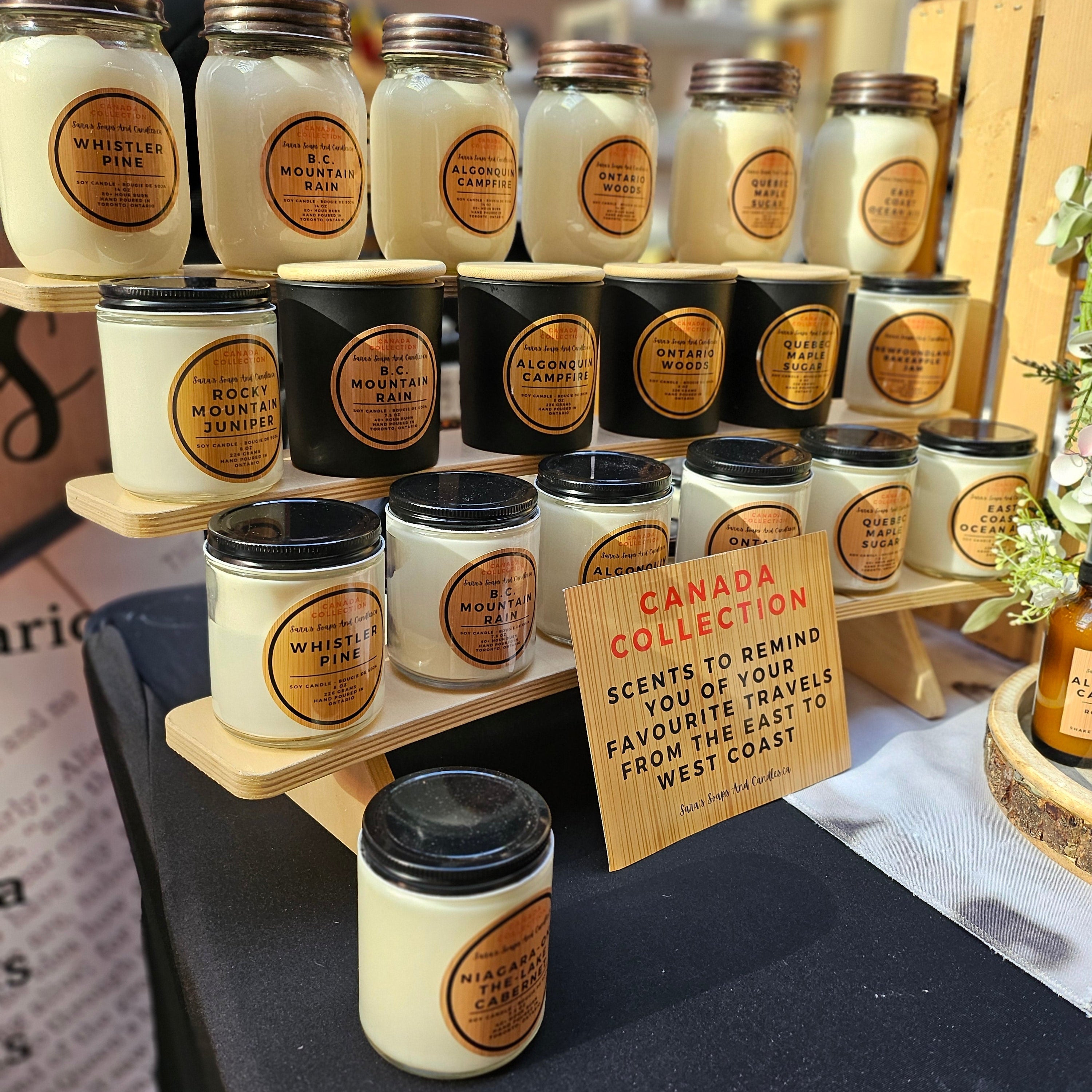 Display of candles with 'Canada Collection' sign on a table