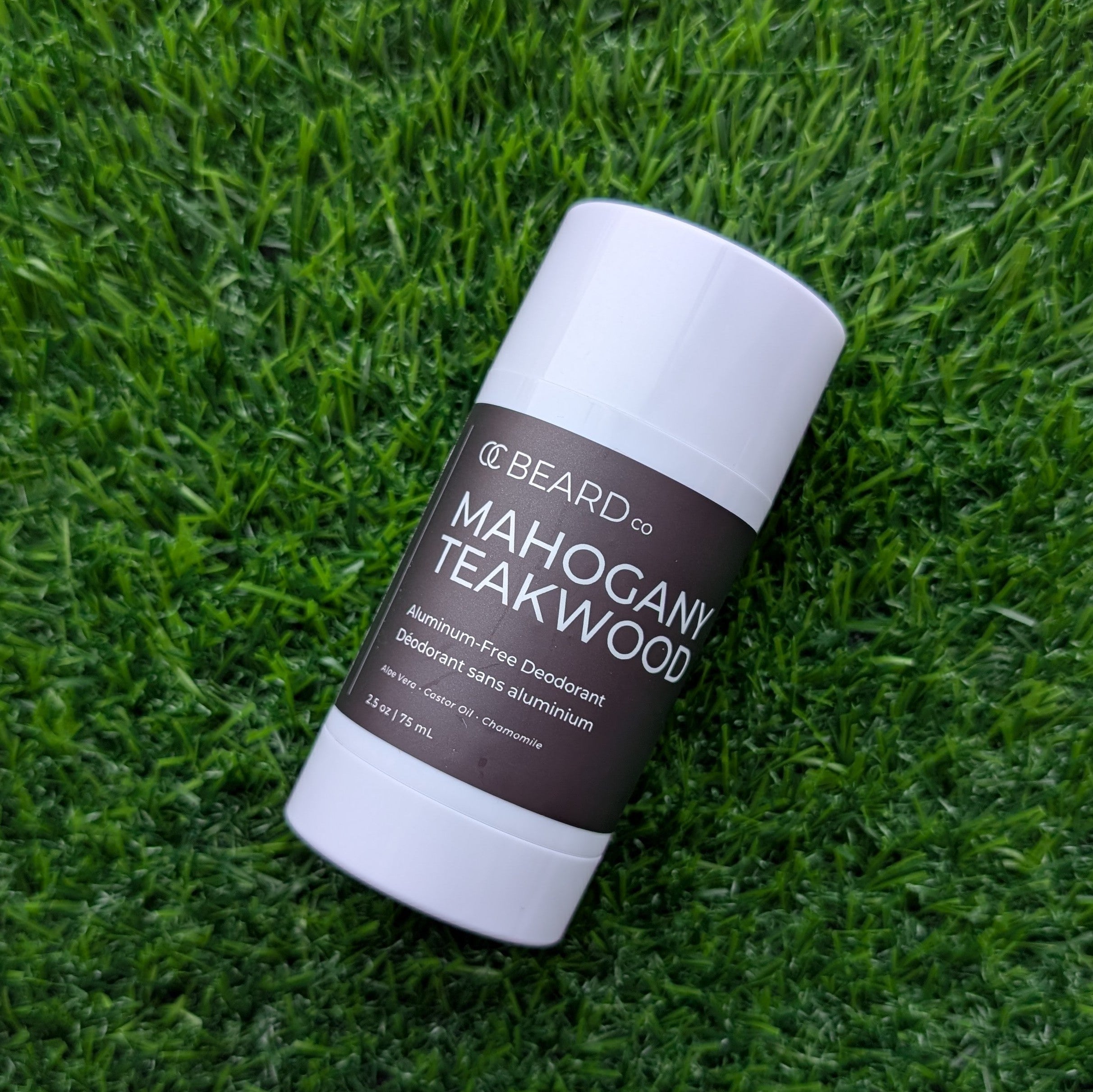 Mahogany Teakwood Natural Deodorant stick with 'Mahogany Teakwood' scent on grass