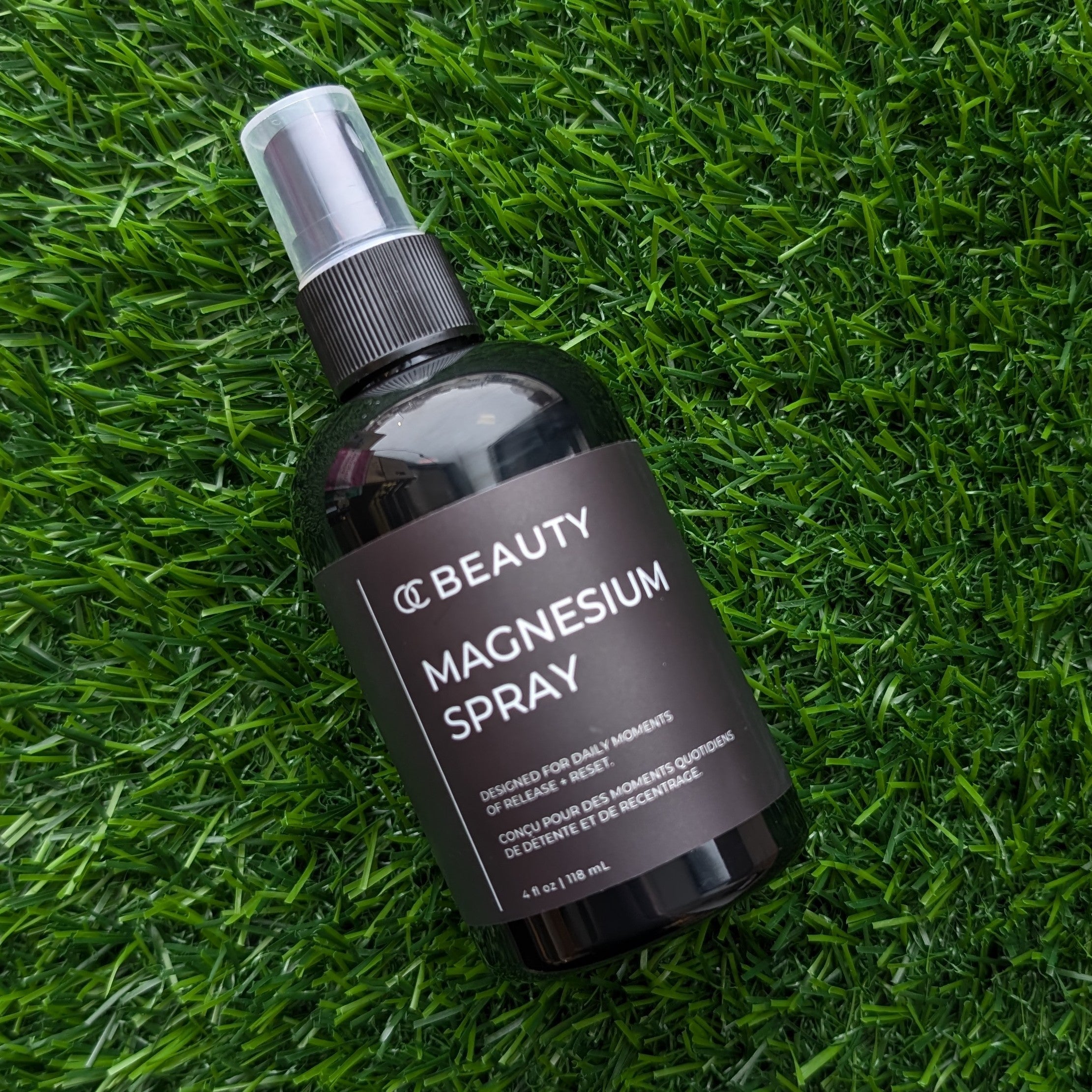 OC Beauty Magnesium Spray bottle on grass