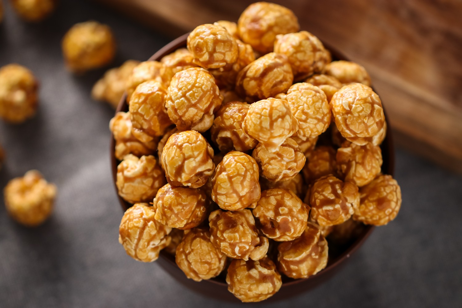 Sea salt and maple popcorn in a wooden bowl on a dark surface from Toronto Popcorn company