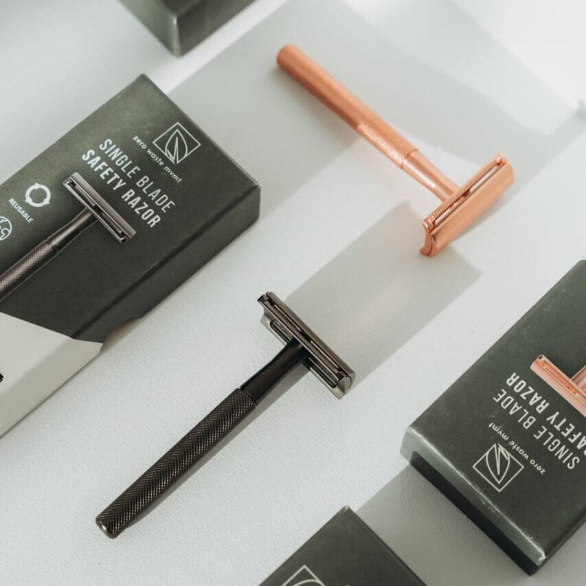 Single blade razors with packaging on a white background